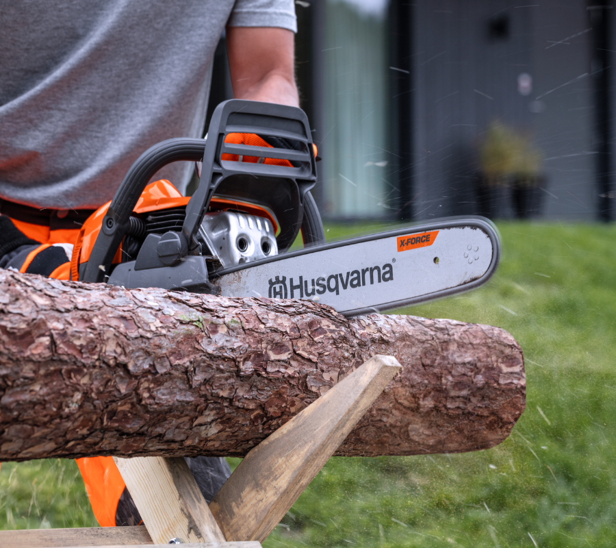 Chainsaw cutting through wood log